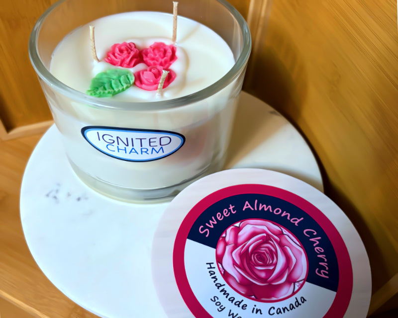 Candle with decorative elements and 'Ignited Charm' branding on a marbled surface.