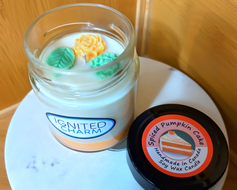 Candle in a jar with decorative elements and a label on a marbled surface