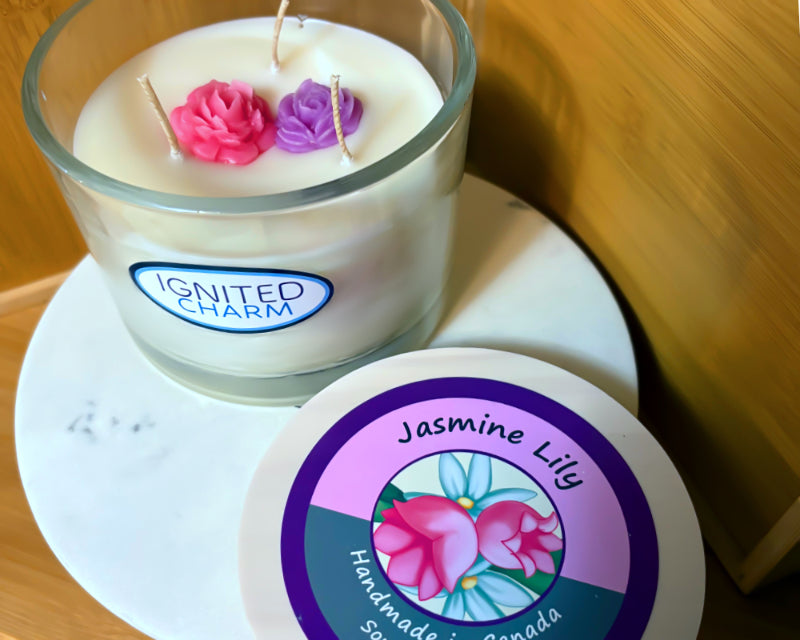Candle with 'Ignited Charm' label and a coaster with 'Jasmine Lily' label on a marble surface.