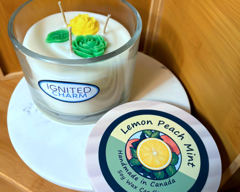 Candle with decorative elements and 'Ignited Charm' branding on a marbled surface
