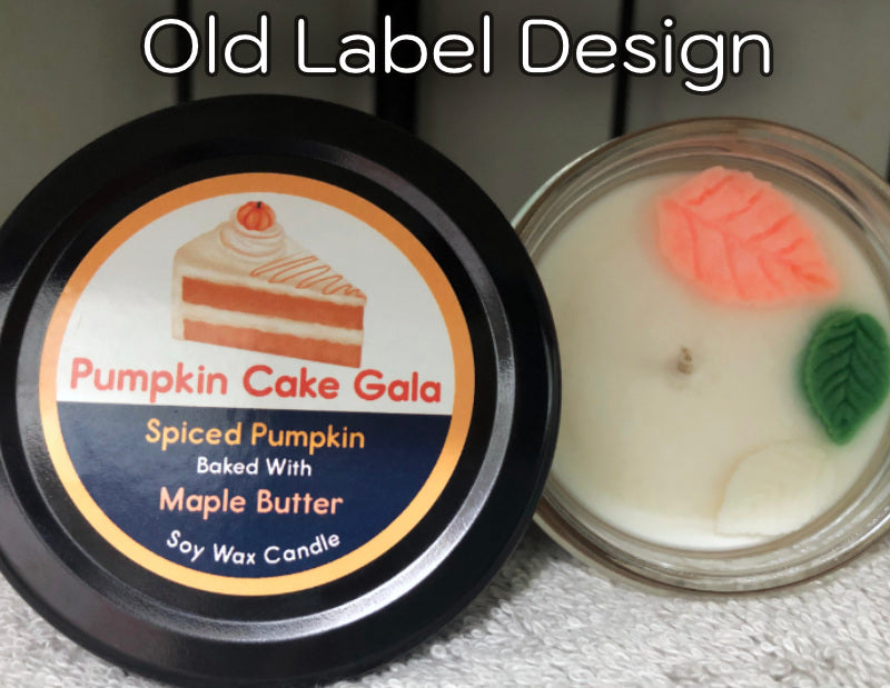 Candle labeled 'Pumpkin Cake Gala' with decorative elements on a textured surface.