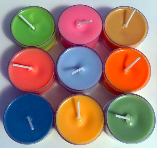Nine colourful candles arranged on a white background