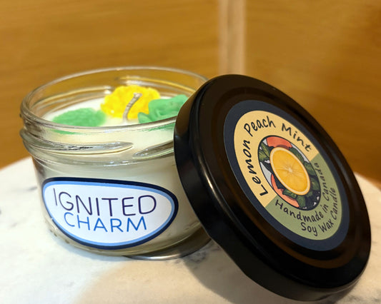 Jar of candle with decorative elements and 'Ignited Charm' label, set against a wooden background.