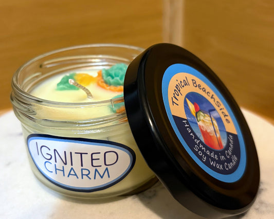 Candle jar with 'Ignited Charm' label and decorative candle on a wooden surface